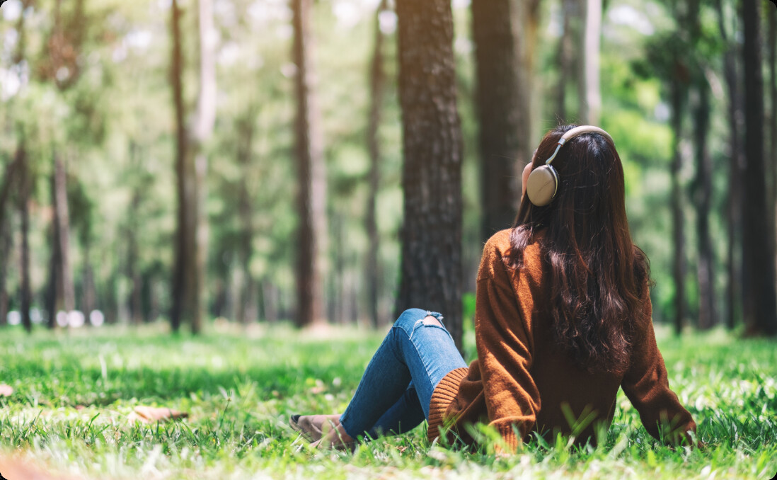 A person relaxing in a wooded park