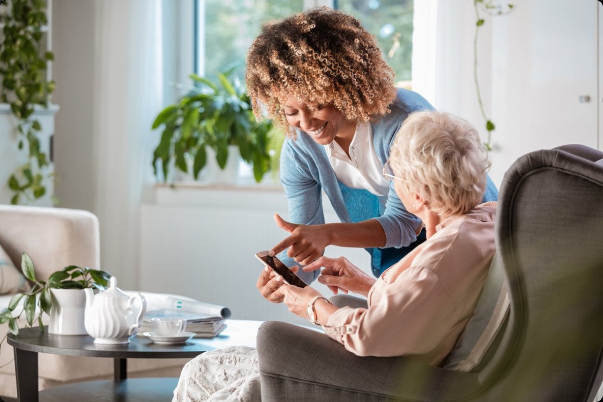 A care professional showing a client something on a phone