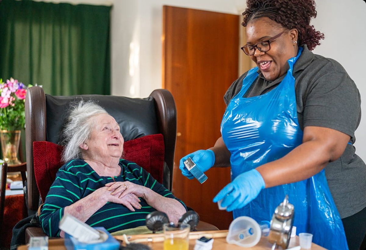 A Seren caregiver helping a woman in her home