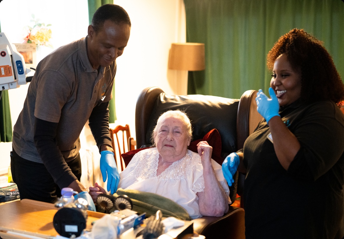 A Seren caregiver and family supporting a woman at home